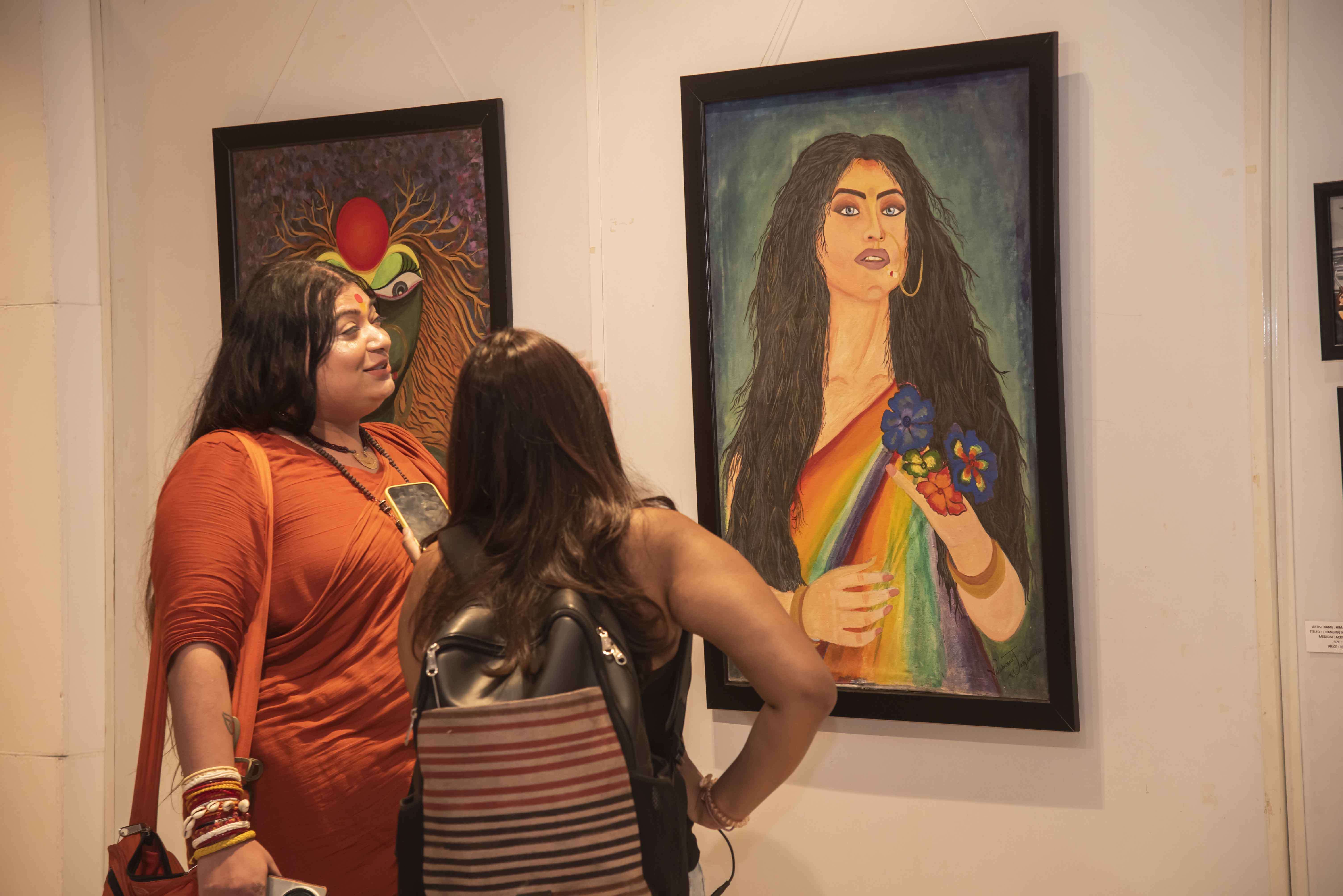 Vaishnavi Jagdamba Nandgiri showing her artwork Unmet Desire to a visitor