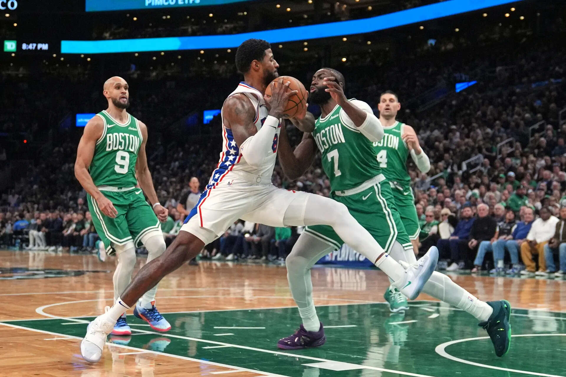 FILE - Philadelphia 76ers forward Paul George (8) drives to the basket against Boston Celtics guard Jaylen Brown (7) during the second half of Game 2 of a first-round NBA playoffs basketball series, April 21, 2026, in Boston. (AP Photo/Charles Krupa, File) Jaylen Brown getting traded by Celtics to 76ers for Paul George, draft picks