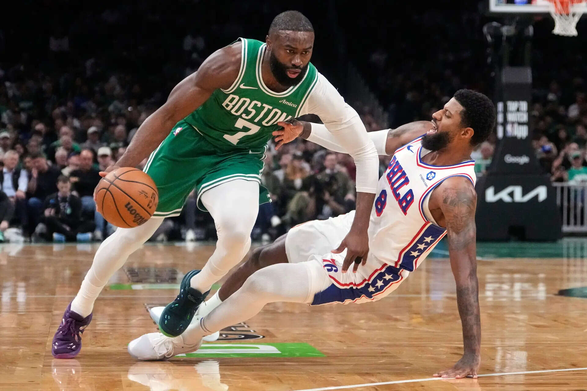 FILE - Boston Celtics guard Jaylen Brown (7) drives to the basket against Philadelphia 76ers forward Paul George (8) during the first half of Game 2 of a first-round NBA playoffs basketball series, April 21, 2026, in Boston. (AP Photo/Charles Krupa, File) Jaylen Brown getting traded by Celtics to 76ers for Paul George, draft picks