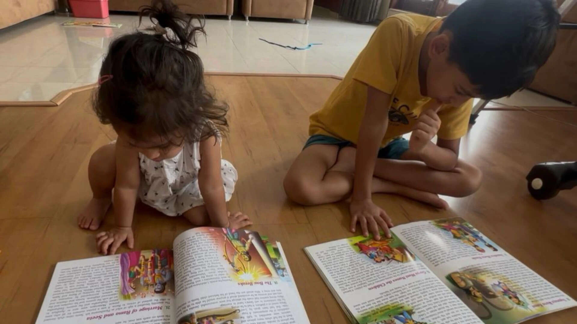Vedarth and his younger sister reading books together