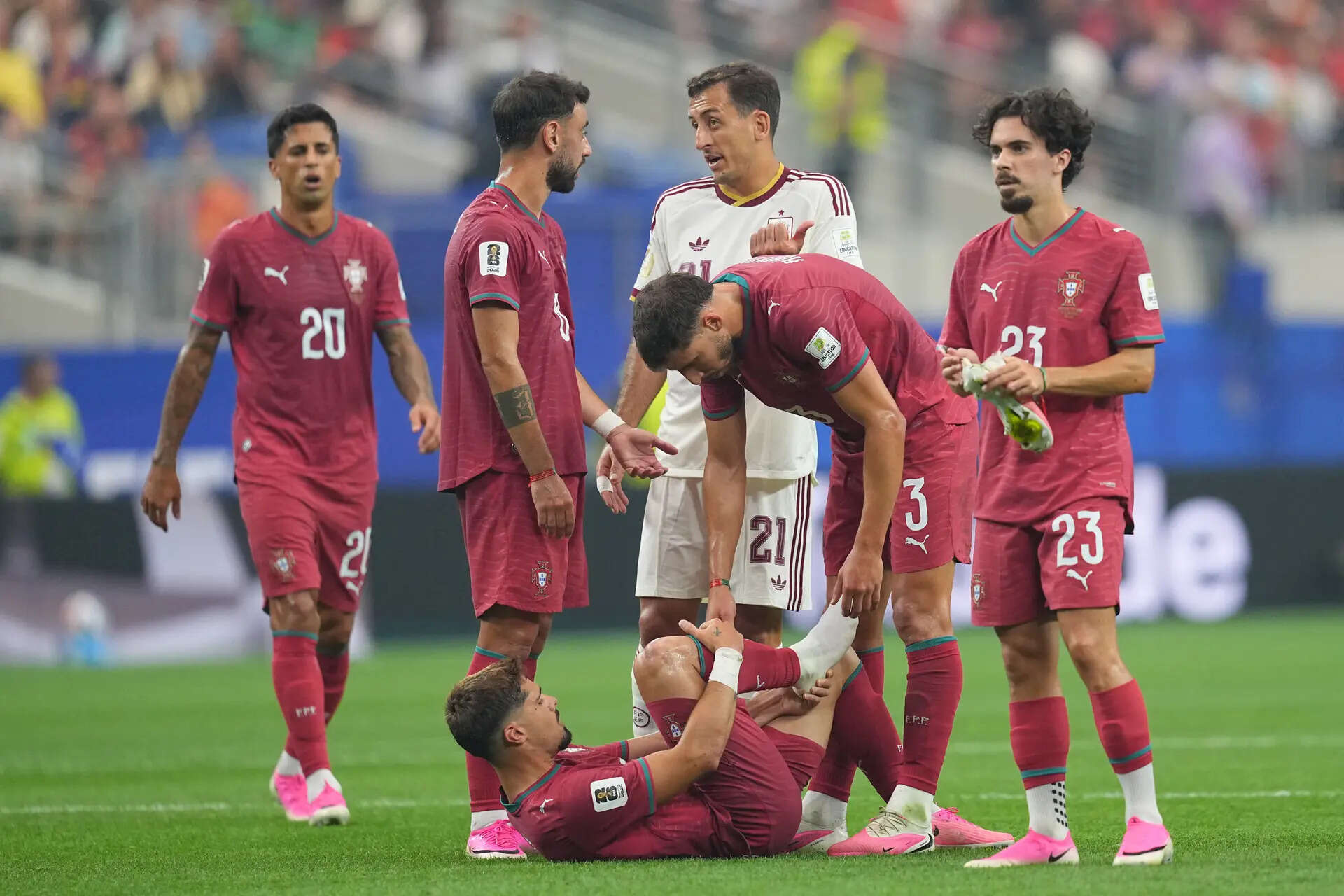 Portugal's Ruben Dias (3) checks on Pedro Neto, bottom, during the World Cup round of 16 soccer match between Portugal and Spain in Arlington, Texas, near Dallas, Monday, July 6, 2026. (AP Photo/Julio Cortez) Spain Portugal WCup Soccer