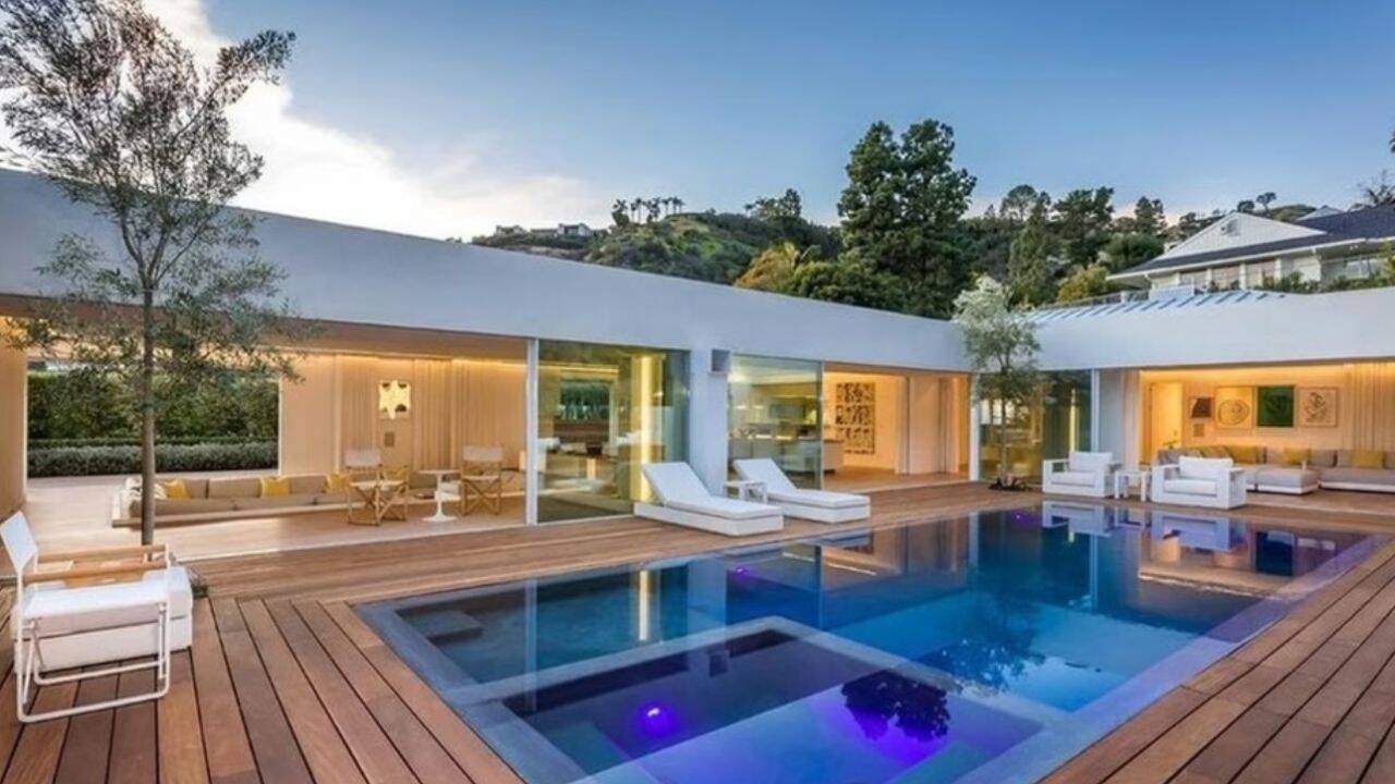 A view of Hollywood actor Orlando Bloom’s former Beverly Hills home, featuring a modern indoor-outdoor layout and a luxury swimming pool .