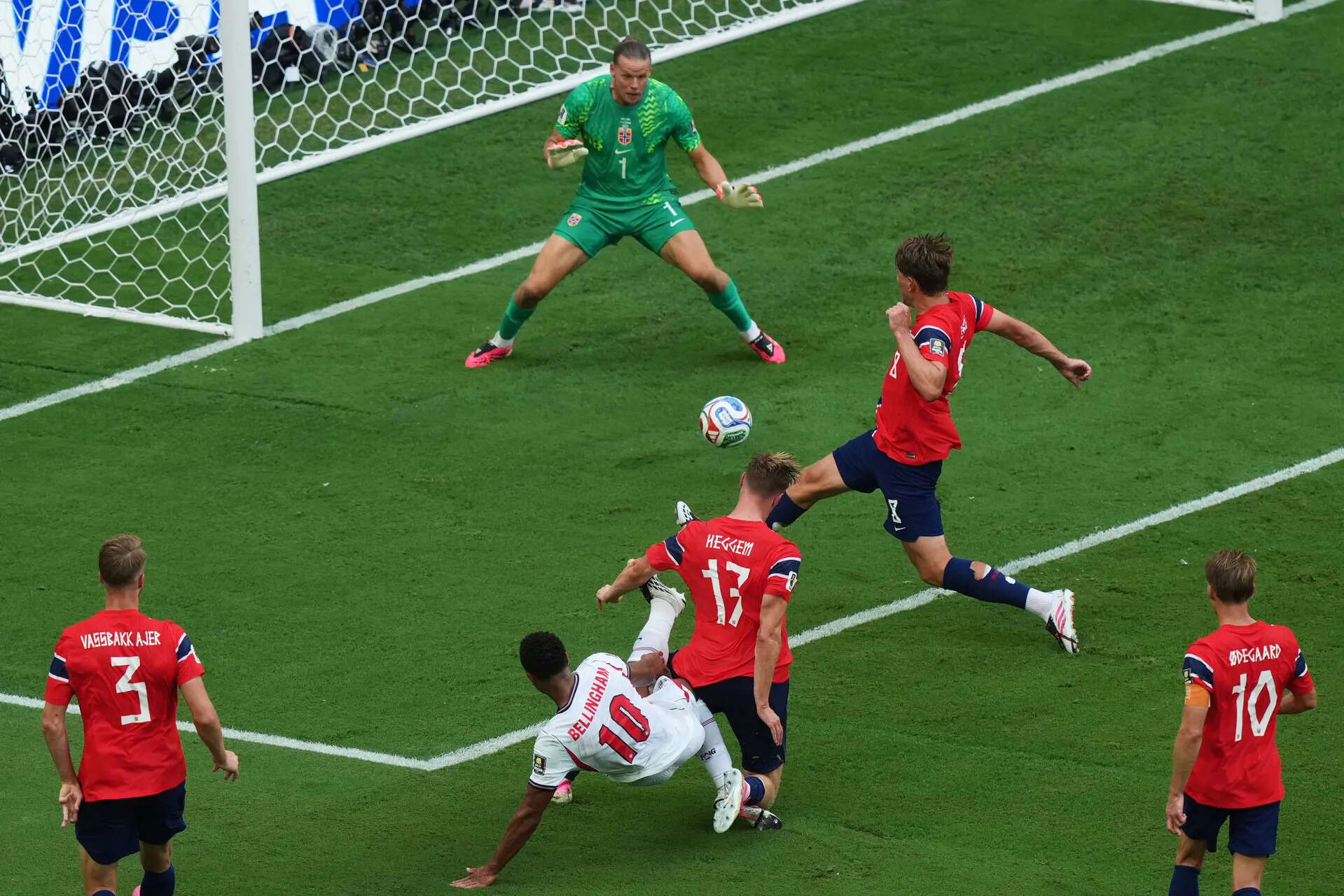 England's Jude Bellingham (10) scores their first goal past Norway goalkeeper Oerjan Nyland (1) during the World Cup quarterfinal soccer match between Norway and England in Miami Gardens, Fla., Saturday, July 11, 2026. (AP Photo/Marta Lavandier) England scores in World Cup match with Norway after ball appears to hit camera cable over field