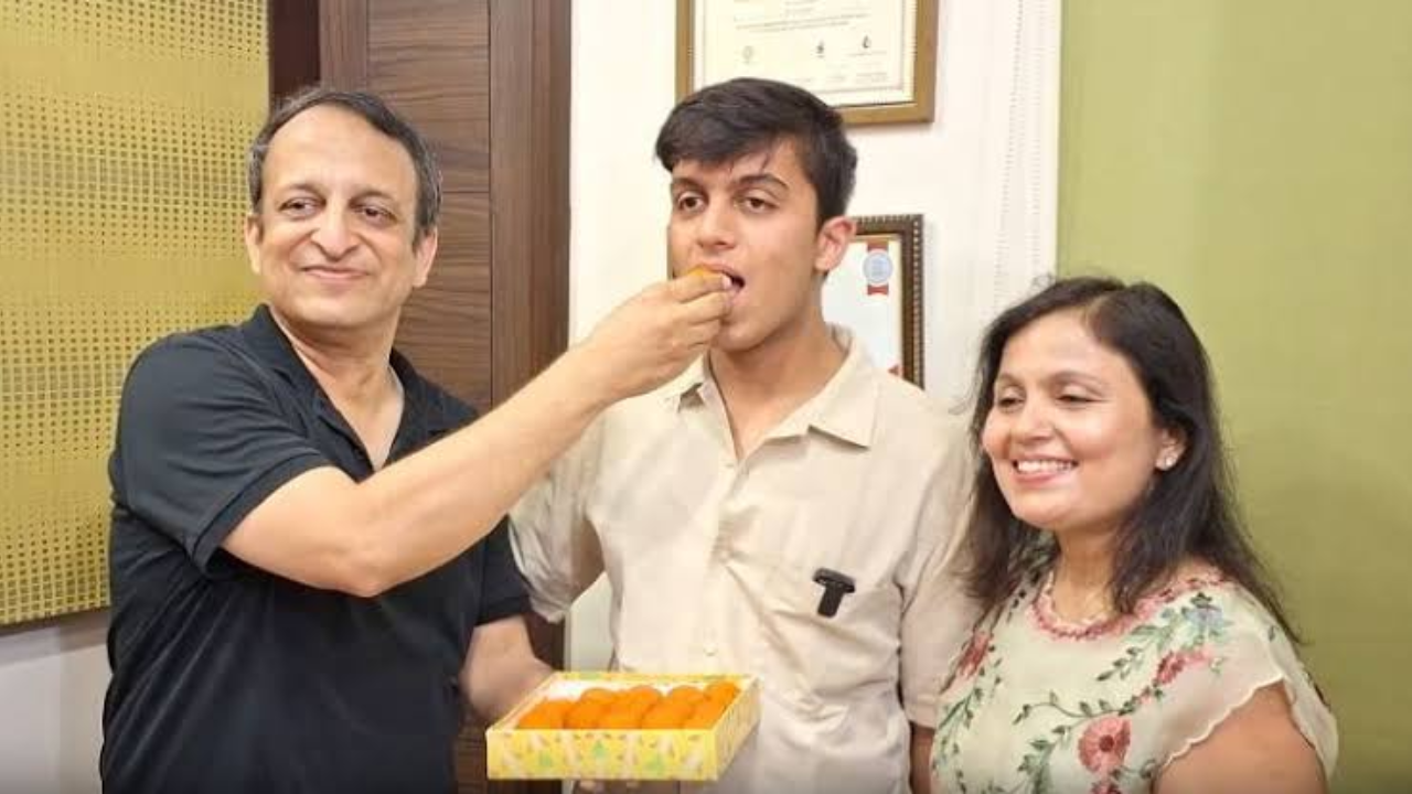 Aryan celebrating with his parents.