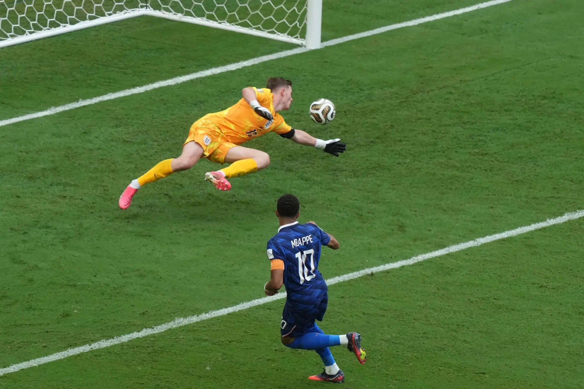 France's Kylian Mbappe (10) scores their first goal past England goalkeeper Dean Henderson (13) during the World Cup third-place playoff soccer match between France and England in Miami Gardens, Fla., Saturday, July 18, 2026. (AP Photo/Marta Lavandier) England France WCup Soccer