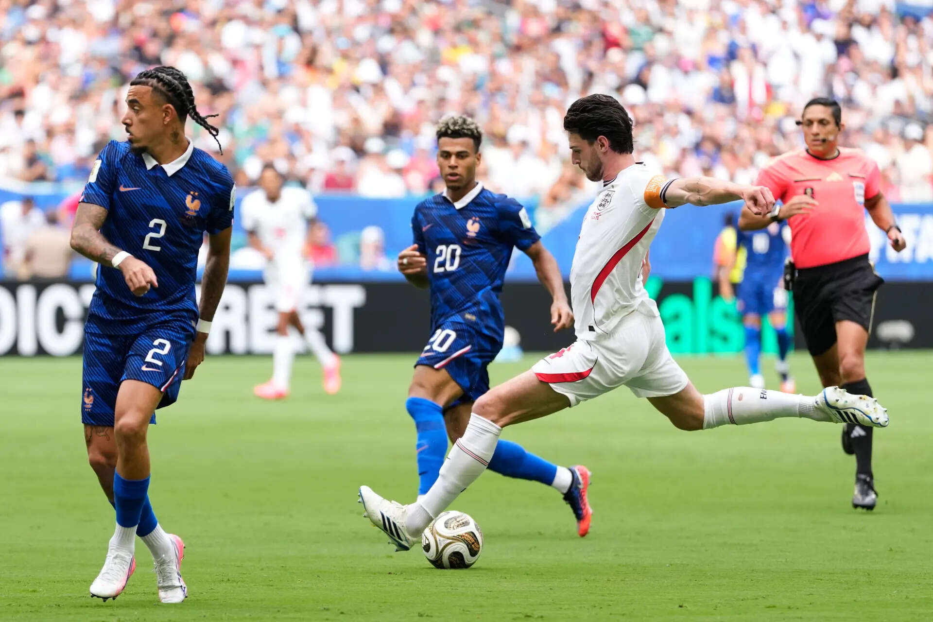England's Declan Rice (4) scores their first goal as France's Malo Gusto (2) and Desire Doue (20) defend during the World Cup third-place playoff soccer match between France and England in Miami Gardens, Fla., Saturday, July 18, 2026. (AP Photo/Rebecca Blackwell) England France WCup Soccer