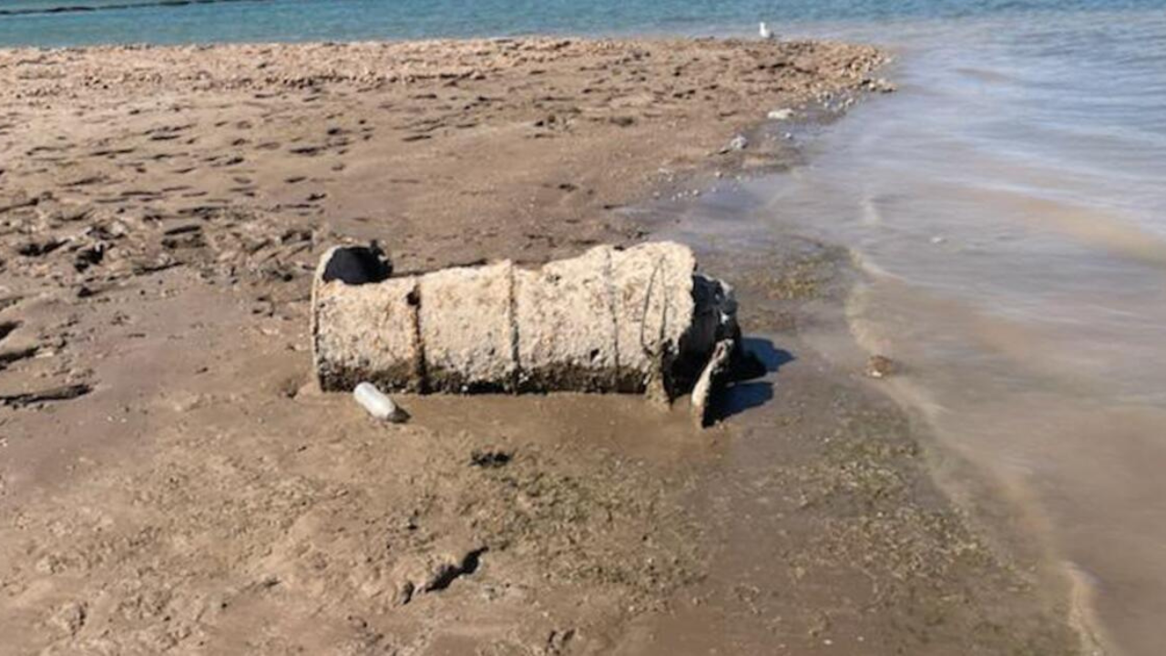 A rusted barrel lies on the exposed shoreline of Lake Mead as falling water levels continue to reveal long-submerged objects