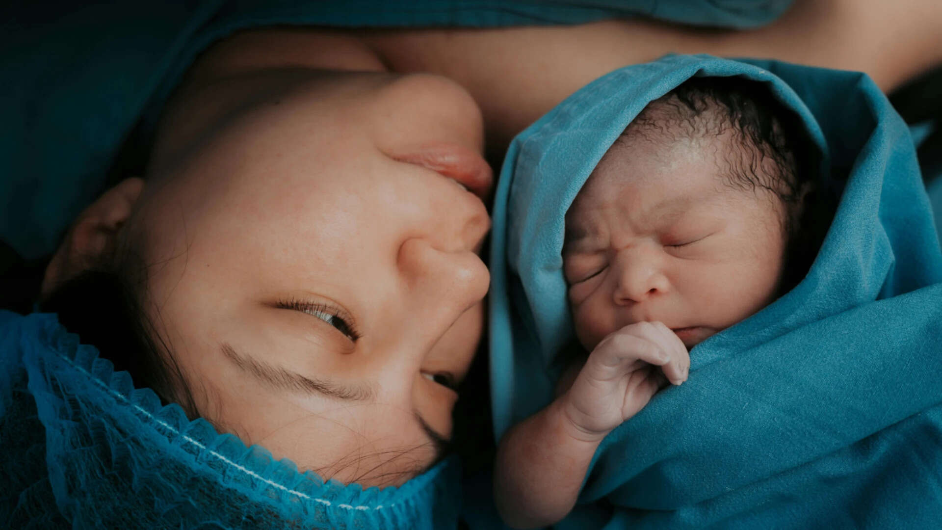 Tender Moment Between Mother and Newborn Baby