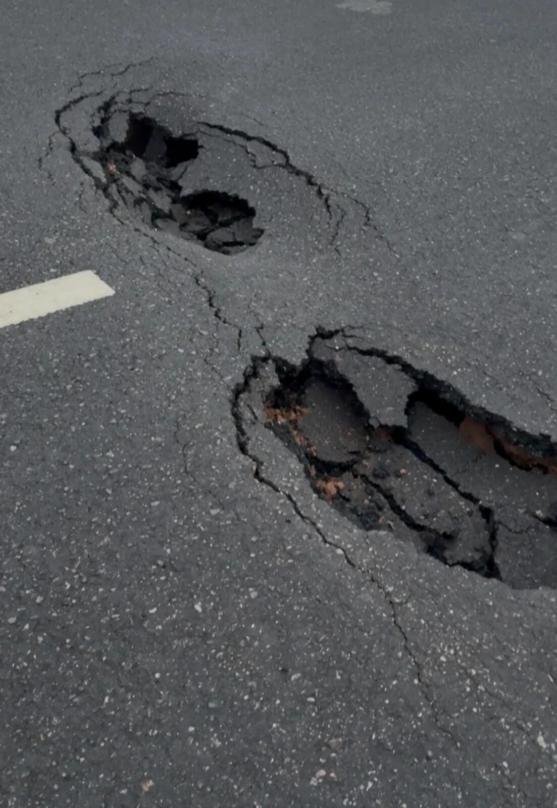Barely months old, Delhi-Doon expressway develops large potholes after season's first monsoon rain.