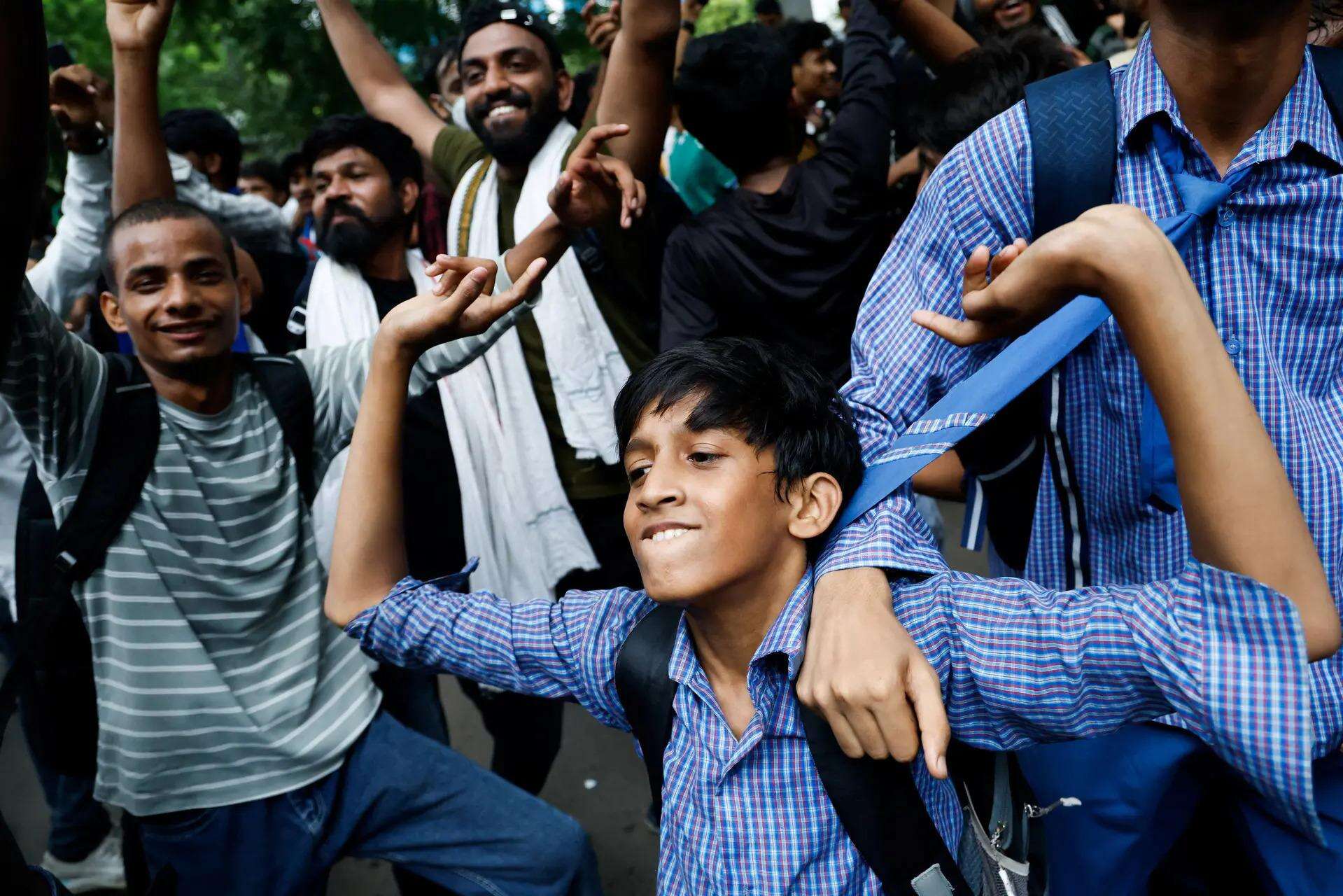 Supporters of  Cockroach Janta Party (CJP) celebrate after Dharmendra Pradhan resigned