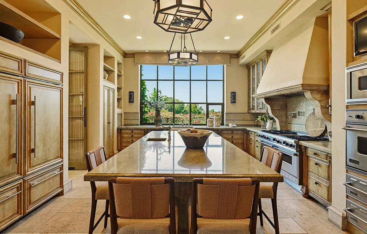 ​A formal dining room with a crystal chandelier is among the highlights of Kaufman’s former Beverly Hills residence.