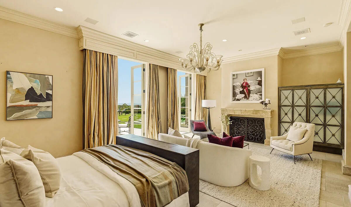 The primary suite features dual walk-in closets and bathrooms, adding to the estate’s luxurious appeal.