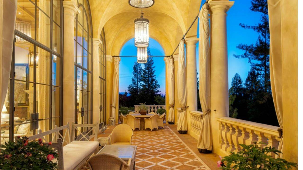 A columned terrace overlooks the estate’s landscaped grounds