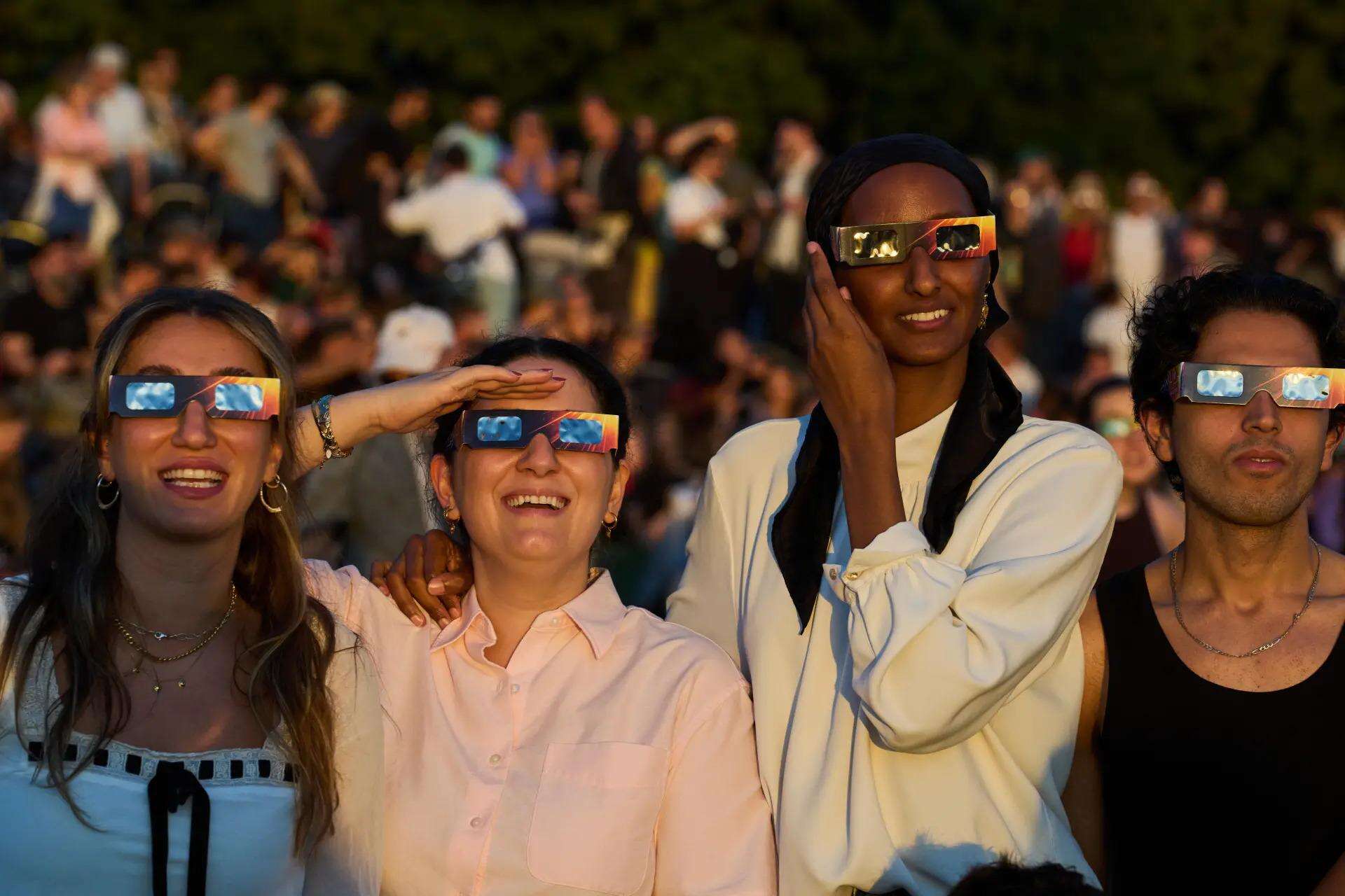 People look towards the sky. (Photo: AP)<br>