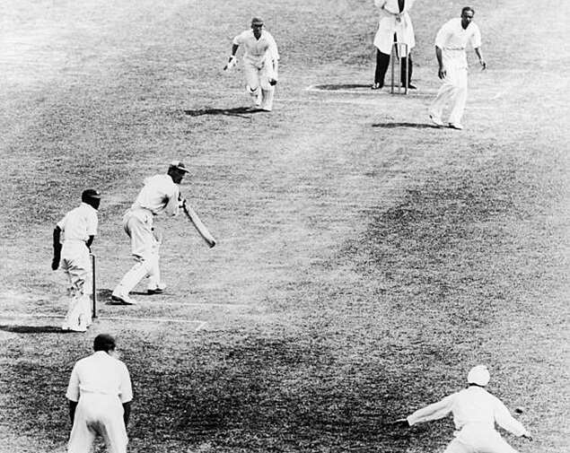 England's Douglas Jardine (second l) edges a ball from India's Amar Singh (top r) past the slips (Photo/Getty Images)<br>