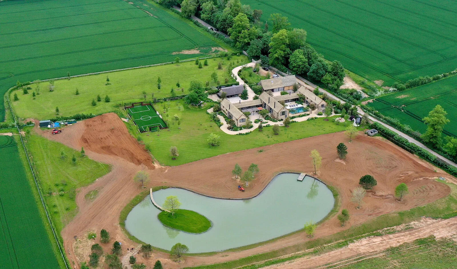 David and Victoria Beckham win planning approval for ‘Blackpool-style’ lake lights, hot tub and firepit at their £6.15 million Cotswolds home despite objections from an Australia-based critic.