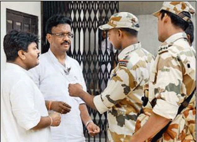 An ITBP jawan checks Firhad Hakim’s identity before letting him inside a polling premises in the Port area on Saturday.