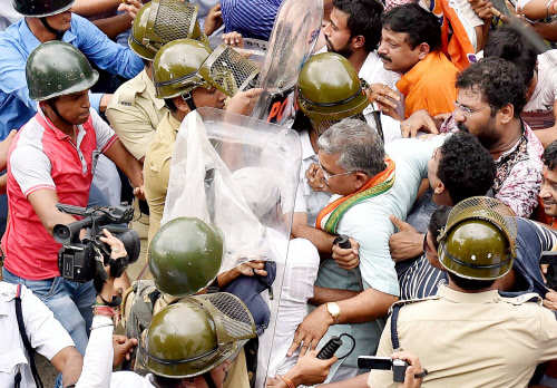  Police try to stop BJP West Bengal State President Dilip Ghosh and his supporters during a protest march against attack on party leader Rupa Ganguly at Kalighat, residence of West Bengal CM Mamata Banerjee in Kolkata on Monday. PTI Photo by Swapan 
