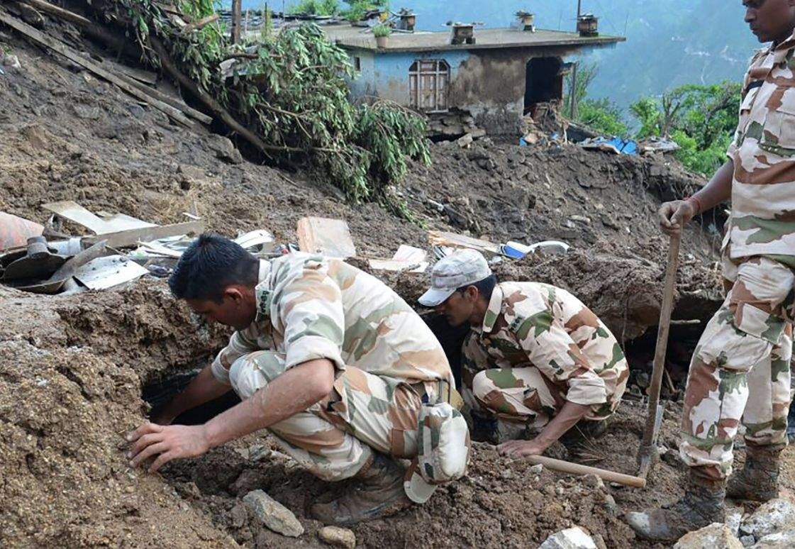 Jawans look for survivors of a landslide following torrential rain in Uttarakhand.