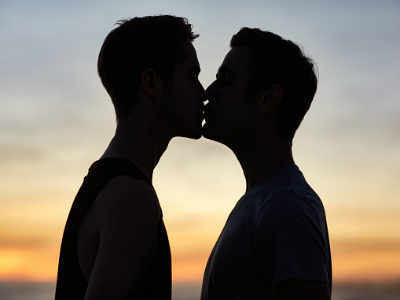 gay men in suits kissing