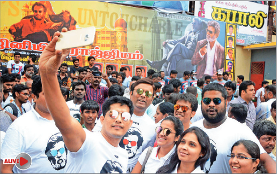 Rajinikanth fans pose for a selfie outside a theatre in Chennai on Friday.