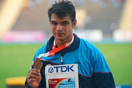 Neeraj Chopra celebrates with the gold medal on the podium. (Getty Images)