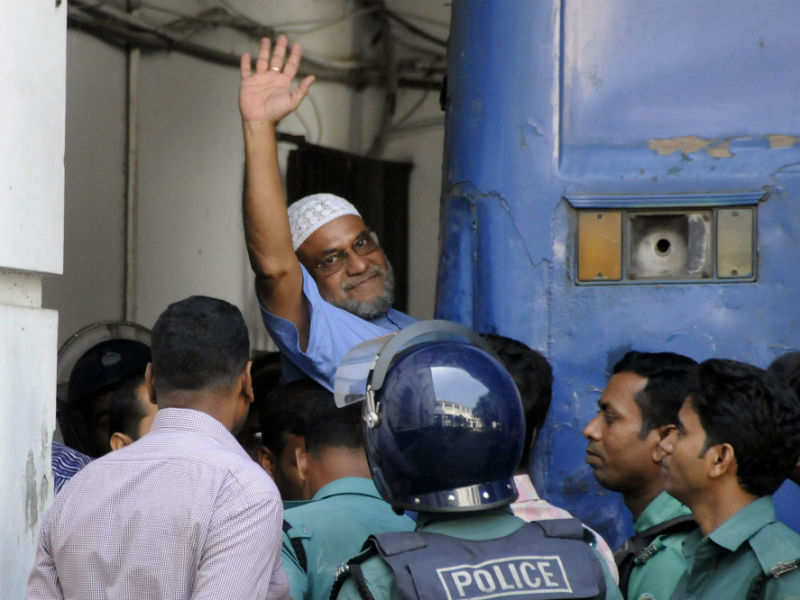 File photograph of November 2, 2014, shows Bangladeshi Jamaat-e-Islami party leader, Mir Quasem Ali waving as he enters a van at the International Crimes Tribunal court in Dhaka. (AFP photo)