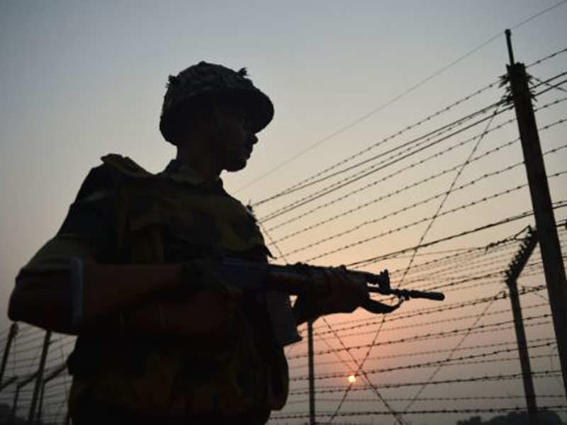 BSF soldier patrols along a fence at the India-Pakistan border in Jammu. (AFP Photo)