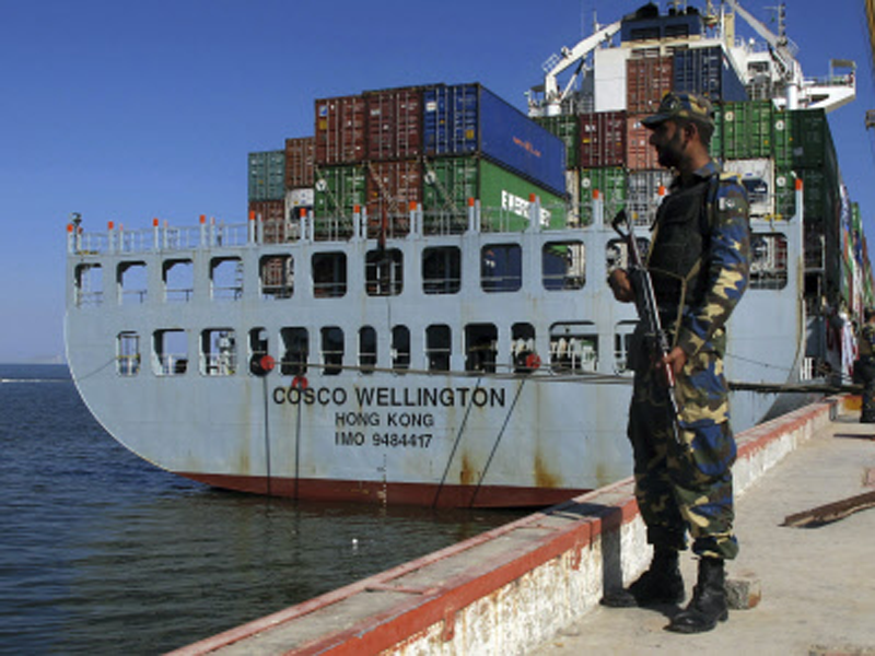 A Pakistan Navy soldier stands guard while a loaded Chinese ship is readied for departure prior to a ceremony at Gwadar port. (AP File Photo)