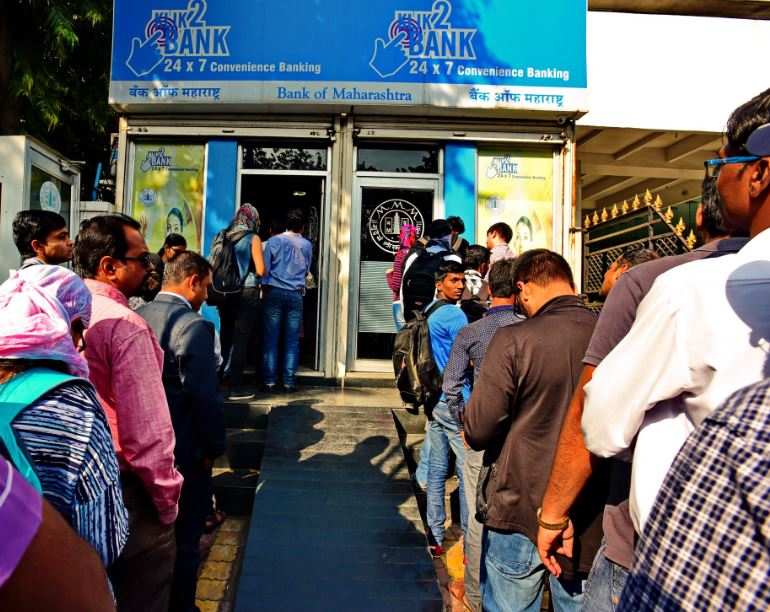 Long queues in front of ATMs.