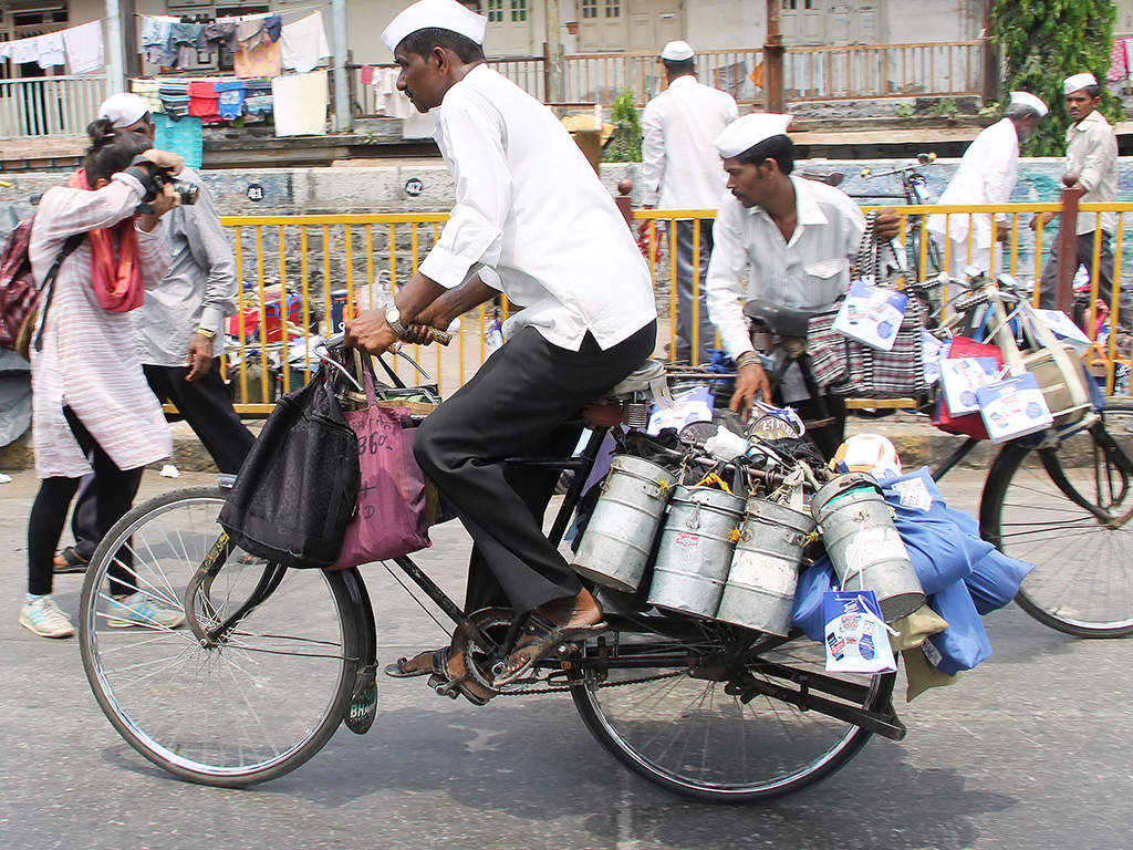 5000 dabbawalla's transporting over 5 lakh lunch boxes from homes to offices and back has never committed any mistake.  (TOI Photo)