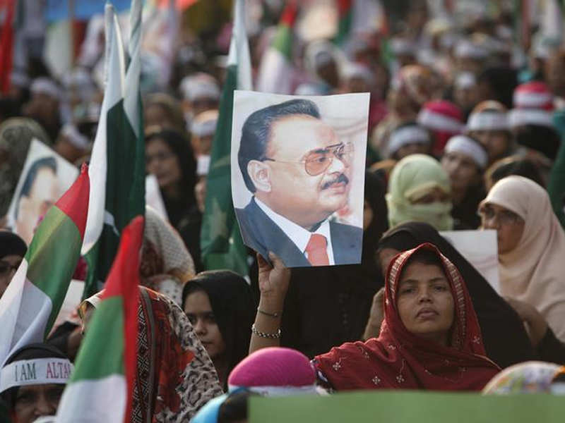 File photo: A supporter of MQM holds a poster with a picture of their leader Altaf Hussain.