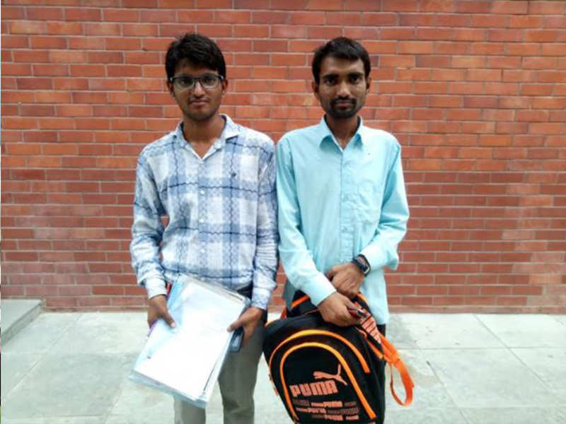 Arvind Sahu (Left) with elder brother Ram Kishore holding bag