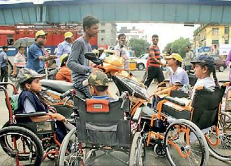 Children from the Indian Institute of Cerebral Palsy speak to a biker on how risky it is to speed on the roads and ride without a helmet.