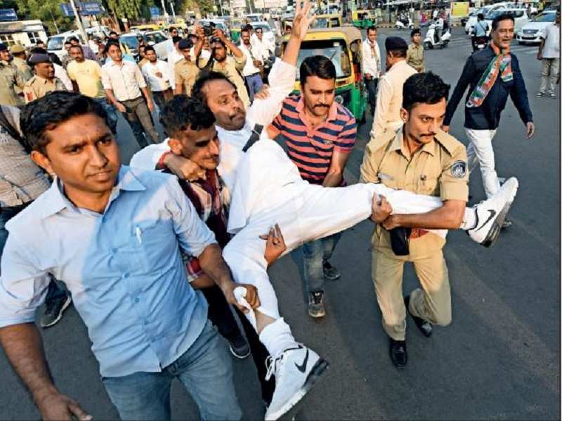 Police detain Congress workers during their protest against demonetization at Stadium Six Roads in Ahmedabad on Wednesday