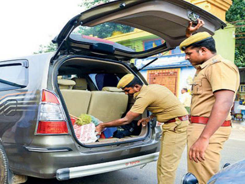 Police personnel inspecting vehicles at RK Nagar
