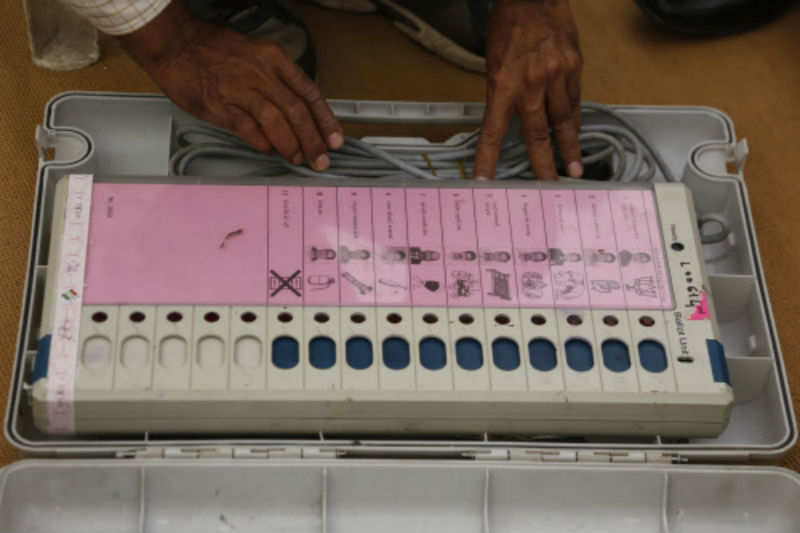 A polling official checks an EVM before the second phase of voting for the Gujarat assembly elections. (AP Photo)