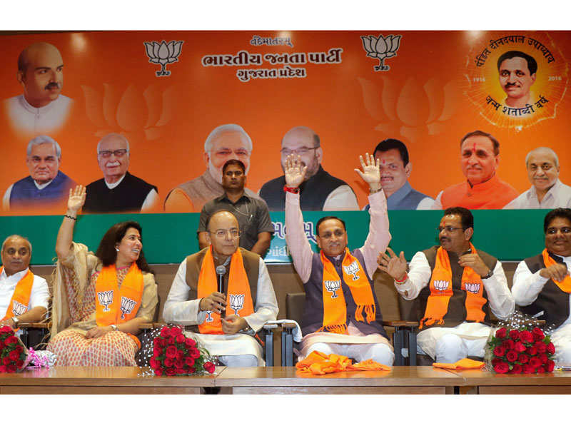 BJP leaders raise hands for counting majority for Gujarat chief minister and deputy chief minister's name at BJP headquarter in Gandhinagar on Friday. (PTI photo)