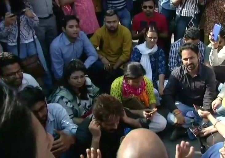 Journalists sit in protest outside Police Headquarters. They are protesting against alleged molestation of a woman journalist by Delhi Cantt SHO. (Photo: ANI)