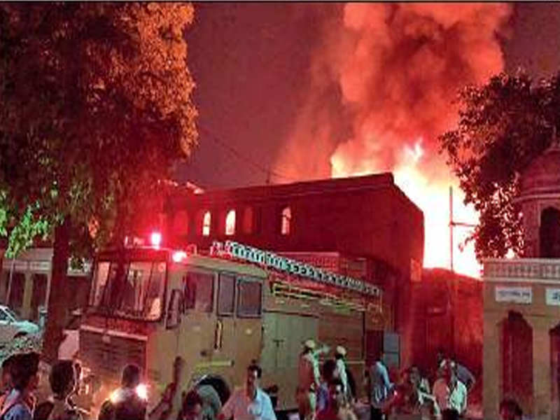 A fire tender tries to douse blaze at wooden warehouse in Walled City