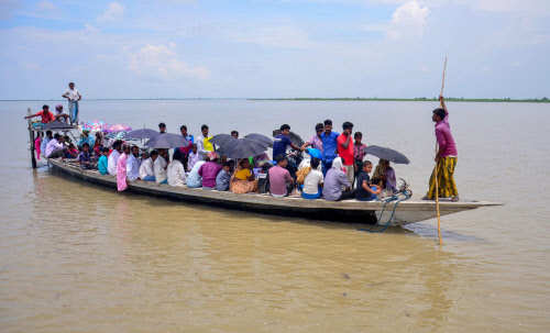 Villagers arrive by boat to check their names in the final draft of the National Register of Citizens (NRC), at a centre at Goroimari after its release, in Kamrup district of Assam