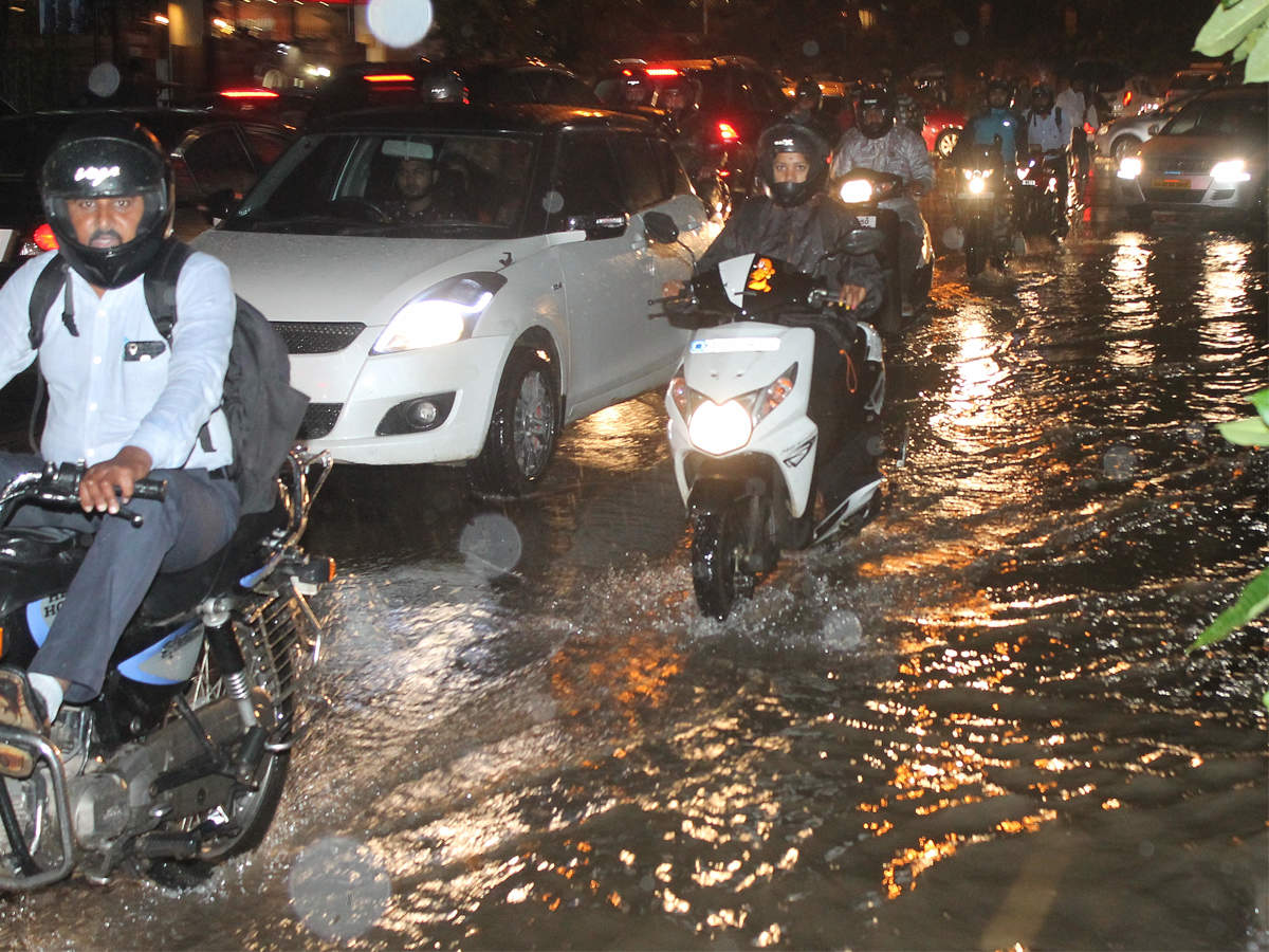 Motorists wade through water on Vittal Mallya Road on Friday