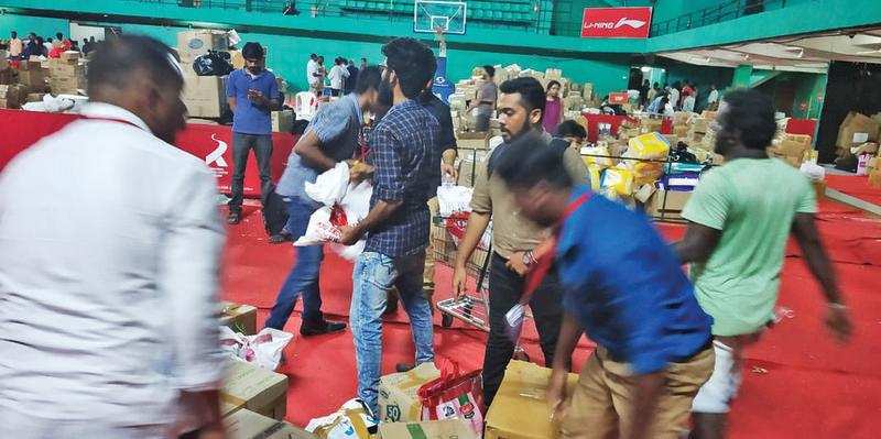 IN FULL SWING: Volunteers deliver materials from TOI collection centre at district administration’s official collection point at Rajiv Gandhi Indoor Stadium in Ernakulam