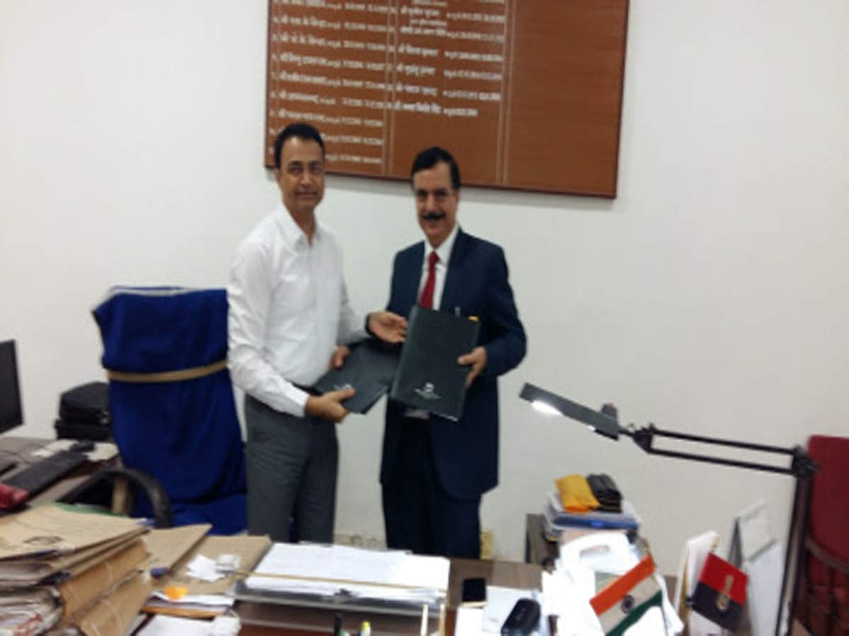 IG (Provision) Kamal Kishore Singh (left) exchanges documents with a senior Tata consultancy services officials after signing an agreement with the private firm for implementation of CCTNS at state 