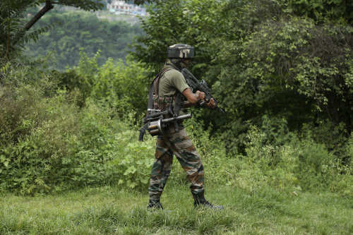 An Army soldier patrols during a search operation after suspected terrorists opened fire near a security check point on the Jammu -Srinagar highway at Jhajjar Kotli about 33 kilometers east of Jammu