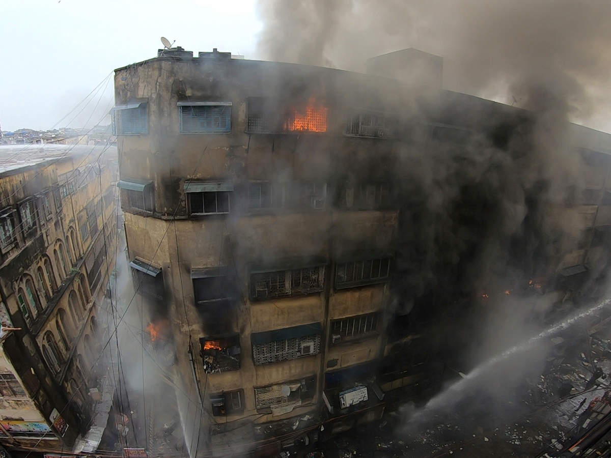Fire fightesr douse the fire at Bagree Market in Kolkata, Sunday.