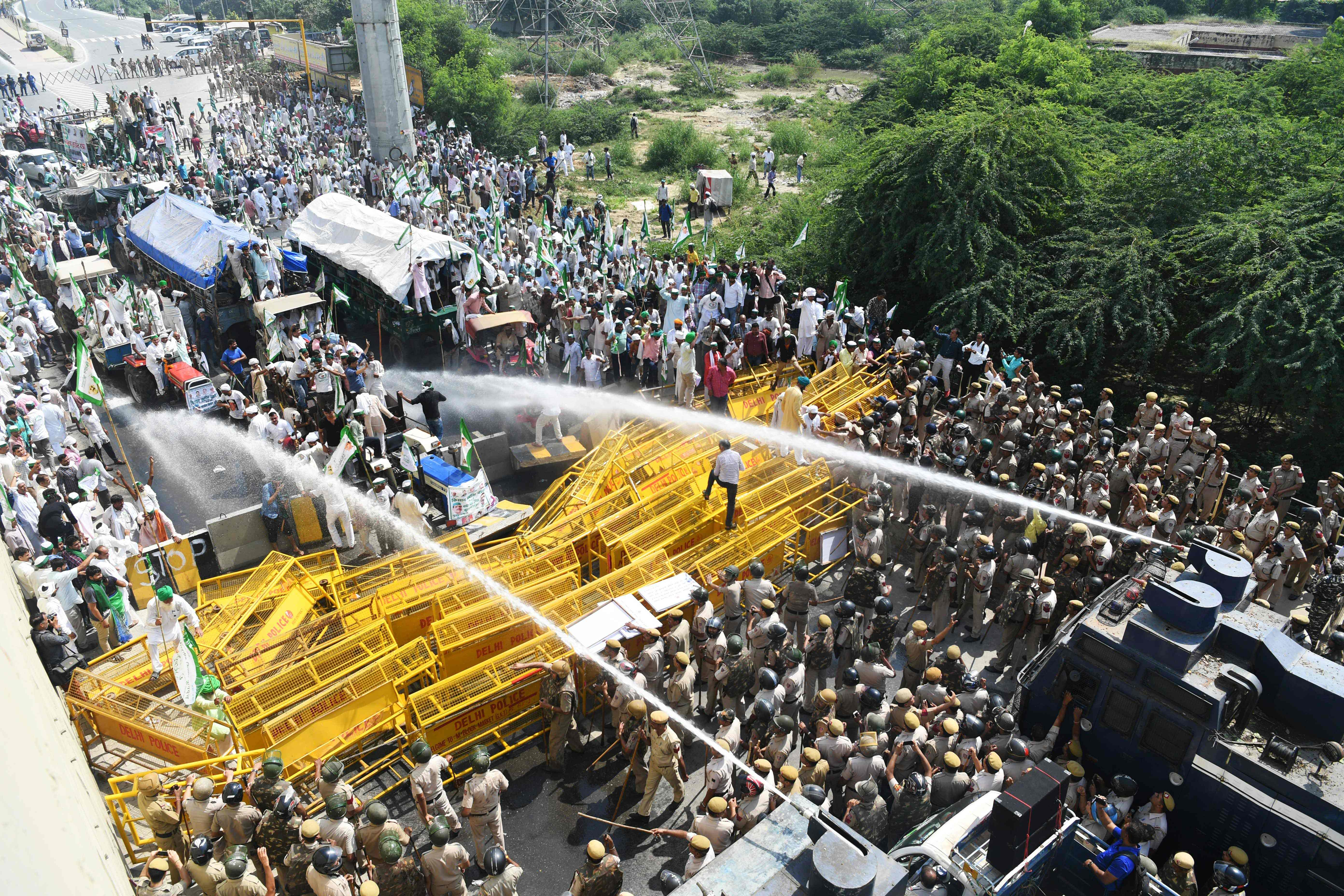 Police use water canons to disperse and stop farmers activists of the Bhartiya Kisan Union at the border with Ghazipur during their march to New Delhi (AFP)