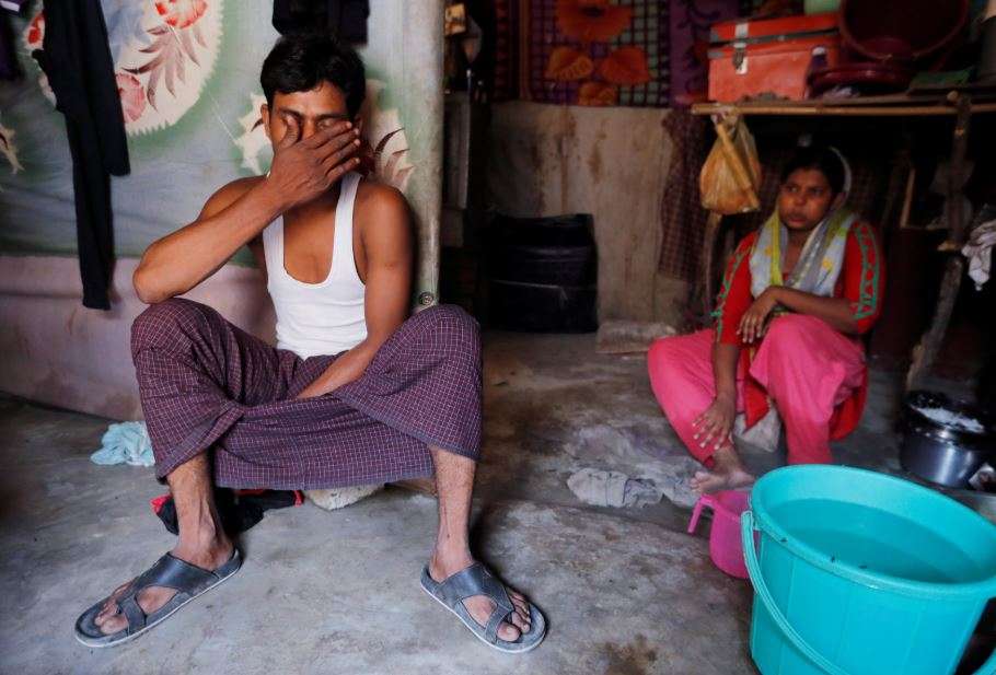 A man from the Rohingya community sits inside his shack with his wife at a camp in New Delhi. (Reuters file photo)