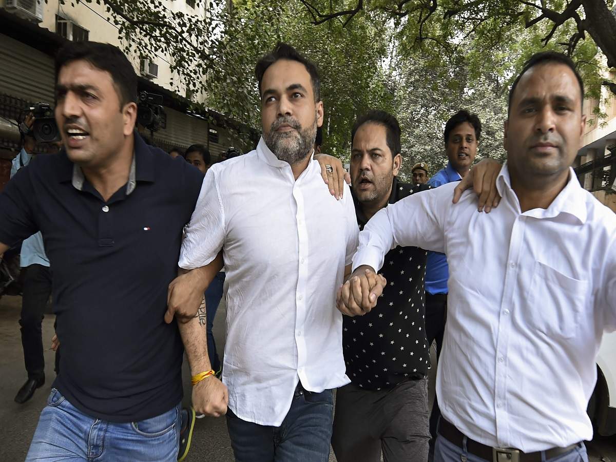 Ashish Pandey (centre), accused of brandishing a gun at guests outside a hotel in Delhi, being brought out of the Patiala House court in Delhi (PTI)