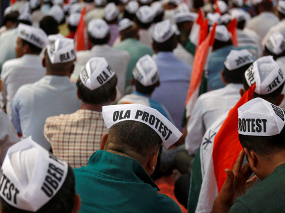 Ola and Uber drivers wearing caps during a protest  in Mumbai on Monday, November 19. (Reuters photo)